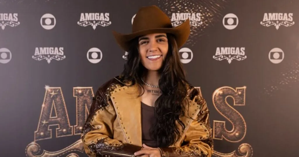 Yasmin Santos de chapéu marrom e figurino de estampa animal na gravação de Amigas.
